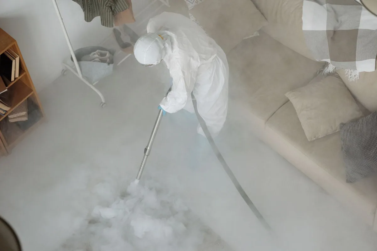 Biohazard cleanup technician in protective equipment, Vineyard Lake, MI